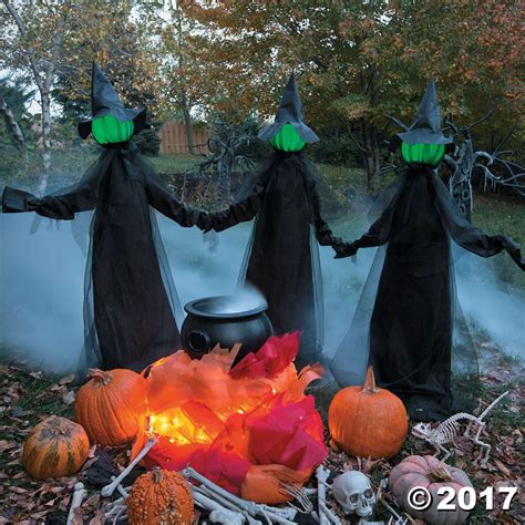 Witch themed halloween decoration crashing into a tree